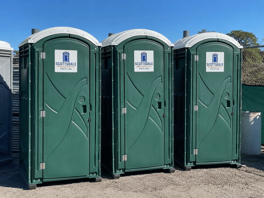 Green standard porta potty rental units lined up and ready for delivery